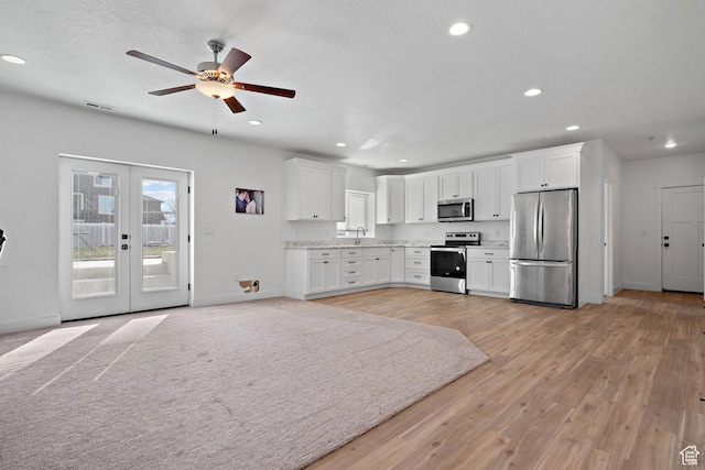 1807 S Bridle Path Loop, Lehi, UT 84043 - kitchen featuring stainless steel appliances, white cabinets, visible vents, baseboards, and ceiling fan