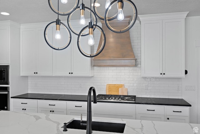 1807 S Bridle Path Loop, Lehi, UT 84043 - kitchen featuring dark stone countertops, backsplash, white cabinetry, and a sink