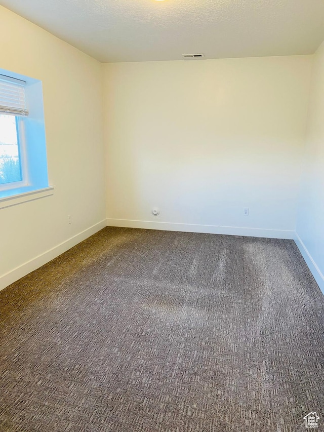 1807 S Bridle Path Loop, Lehi, UT 84043 - empty room with baseboards, visible vents, and dark carpet