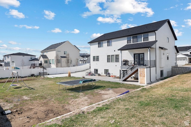 1807 S Bridle Path Loop, Lehi, UT 84043 - rear view of property with stairway, a trampoline, a fenced backyard, and a residential view