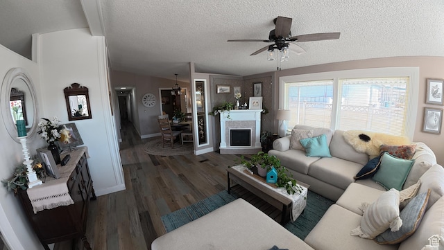 102 W Alta View Way Unit 7, Sandy, UT 84070 - living room with a textured ceiling, ceiling fan, a fireplace, dark wood-type flooring, and lofted ceiling