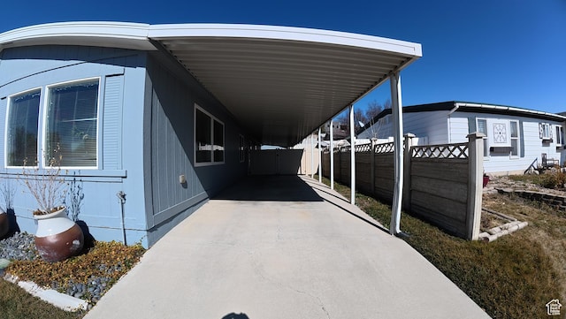 102 W Alta View Way Unit 7, Sandy, UT 84070 - view of property exterior with driveway, a carport, and fence
