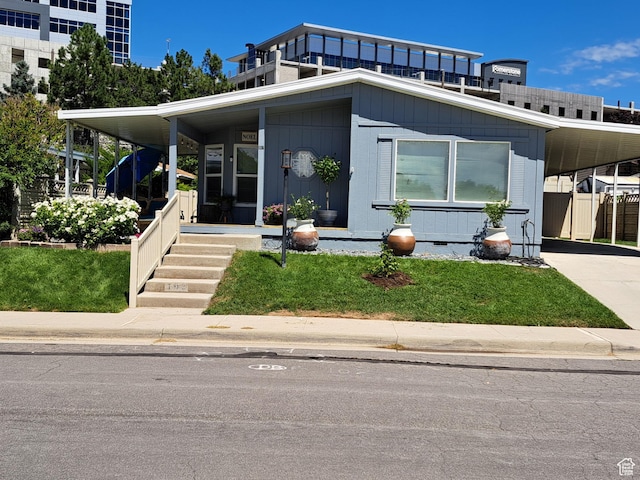 view of front of property with a carport, covered porch, and concrete driveway