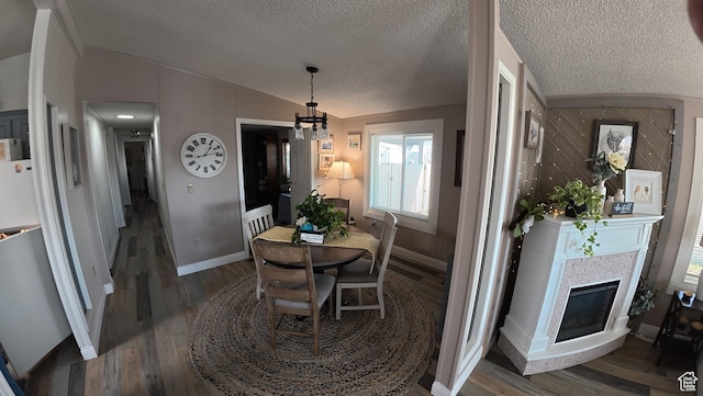 102 W Alta View Way Unit 7, Sandy, UT 84070 - dining room with a textured ceiling, baseboards, wood finished floors, lofted ceiling, and a glass covered fireplace