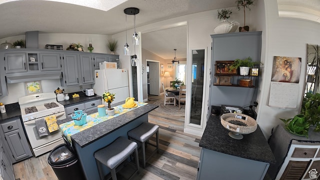102 W Alta View Way Unit 7, Sandy, UT 84070 - kitchen with gray cabinets, dark countertops, vaulted ceiling, and white appliances