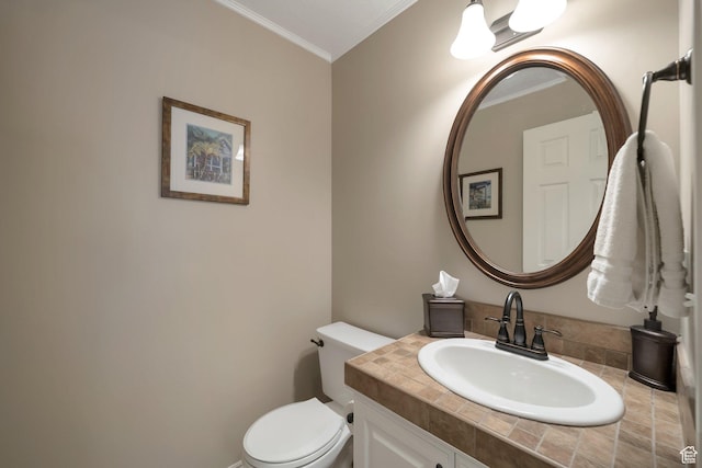 half bathroom with toilet, vanity, and ornamental molding
