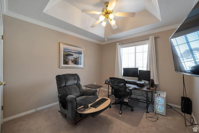 home office with crown molding, a ceiling fan, a raised ceiling, baseboards, and carpet
