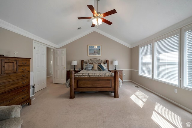 bedroom featuring crown molding, vaulted ceiling, baseboards, ceiling fan, and light carpet