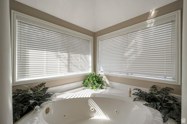 full bathroom with a tub with jets