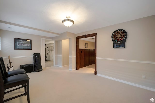 office space featuring baseboards, visible vents, and carpet flooring