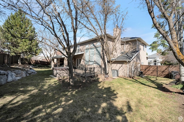 view of yard with a fenced backyard and a wooden deck