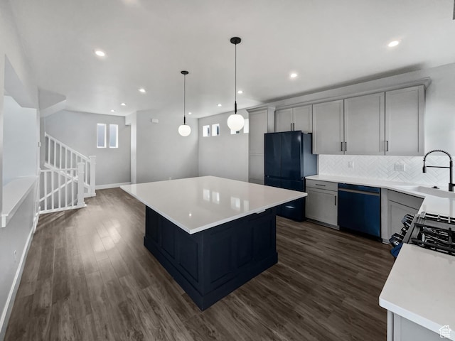 kitchen with dishwashing machine, a sink, a center island, and dark wood finished floors