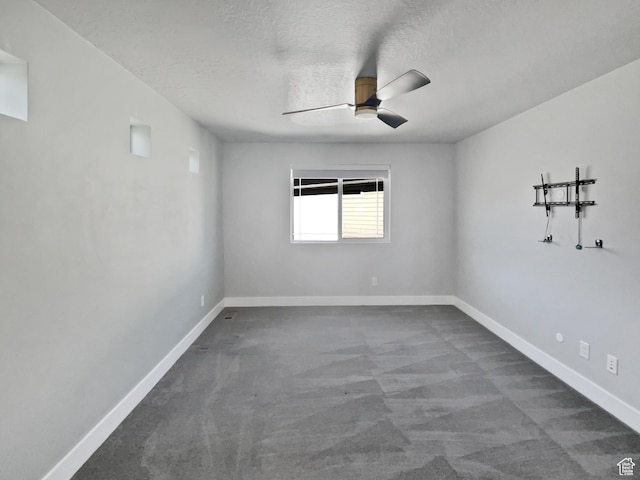 spare room featuring carpet floors, baseboards, ceiling fan, and a textured ceiling