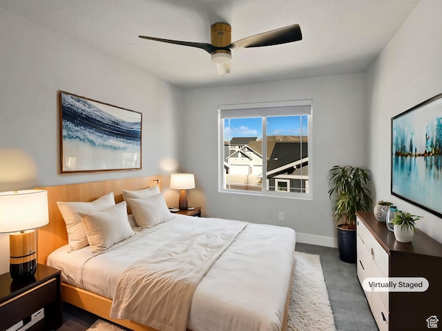 bedroom with baseboards, ceiling fan, and dark colored carpet