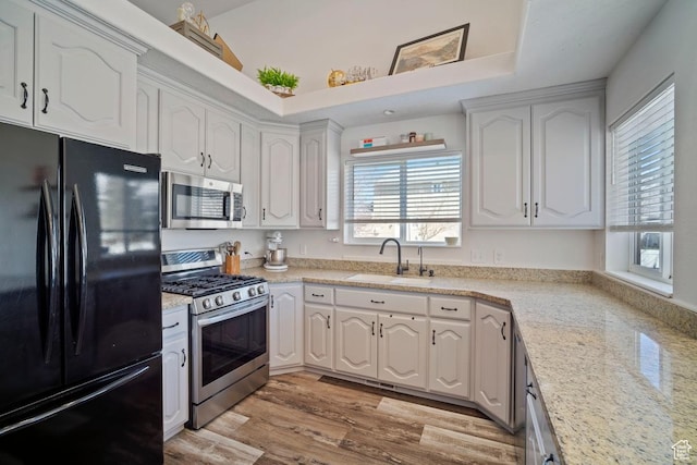28 E 1400 N, Mapleton, UT 84664 - kitchen with light wood finished floors, a sink, white cabinets, and appliances with stainless steel finishes