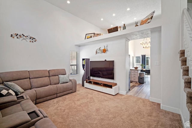 28 E 1400 N, Mapleton, UT 84664 - living room with light colored carpet, a towering ceiling, baseboards, and a chandelier