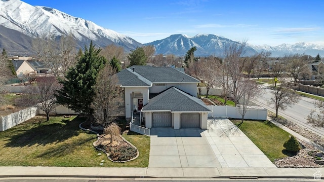 28 E 1400 N, Mapleton, UT 84664 - view of front of house featuring an attached garage, concrete driveway, a front lawn, a mountain view, and fence private yard