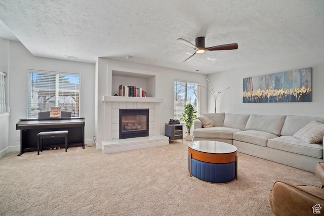 28 E 1400 N, Mapleton, UT 84664 - carpeted living area with a textured ceiling, a tile fireplace, baseboards, and a ceiling fan