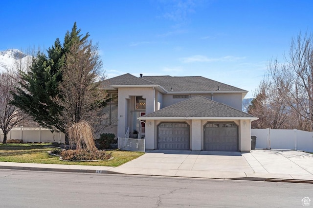 28 E 1400 N, Mapleton, UT 84664 - view of front facade with stucco siding, fence, an attached garage, driveway, and a gate