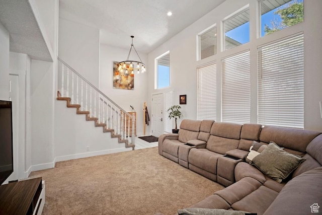 28 E 1400 N, Mapleton, UT 84664 - living area featuring a notable chandelier, carpet floors, stairway, a high ceiling, and baseboards