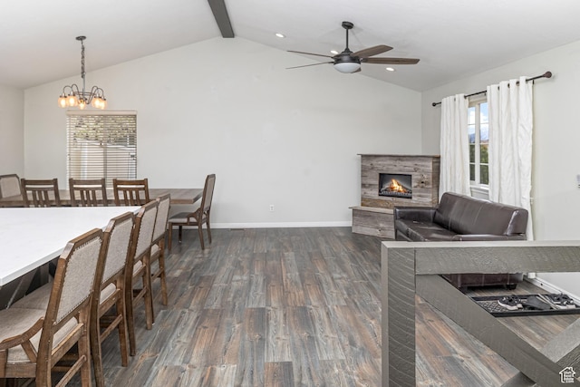444 E 2720 N, North Logan, UT 84341 - living area with vaulted ceiling, a lit fireplace, dark wood-style floors, a ceiling fan, and baseboards