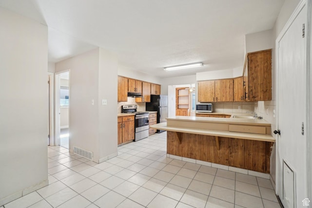 240 W 220 S, Orem, UT 84058 - kitchen with light tile patterned flooring, light countertops, appliances with stainless steel finishes, a peninsula, and visible vents