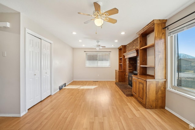 240 W 220 S, Orem, UT 84058 - unfurnished living room with visible vents, a healthy amount of sunlight, light wood finished floors, and ceiling fan