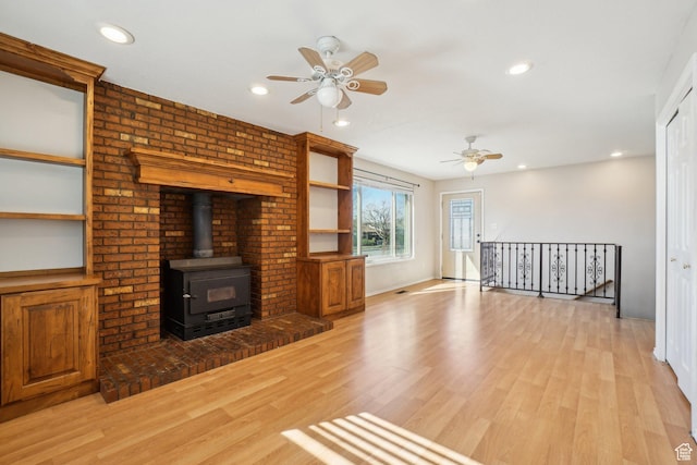 240 W 220 S, Orem, UT 84058 - unfurnished living room featuring light wood-style flooring, a wood stove, recessed lighting, and a ceiling fan