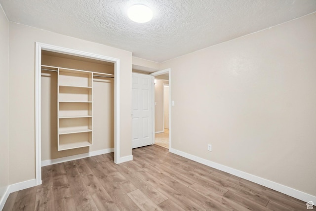 240 W 220 S, Orem, UT 84058 - unfurnished bedroom with baseboards, a closet, light wood-style floors, and a textured ceiling