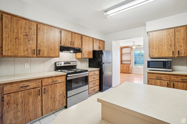 240 W 220 S, Orem, UT 84058 - kitchen with backsplash, under cabinet range hood, appliances with stainless steel finishes, and light countertops