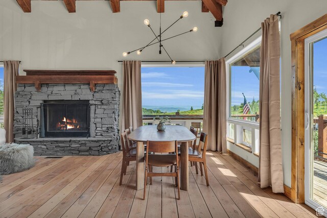 2421 S Navajo Unit Pi-C50, Coalville, UT 84017 - dining area featuring hardwood / wood-style floors, a stone fireplace, baseboards, and beamed ceiling