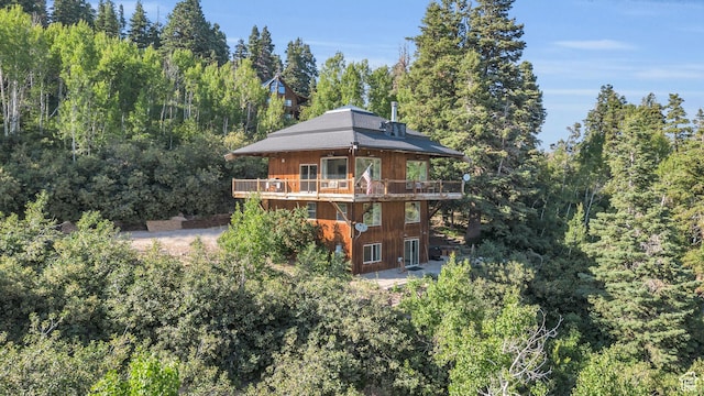 2421 S Navajo Unit Pi-C50, Coalville, UT 84017 - rear view of house featuring a wooded view and a wooden deck