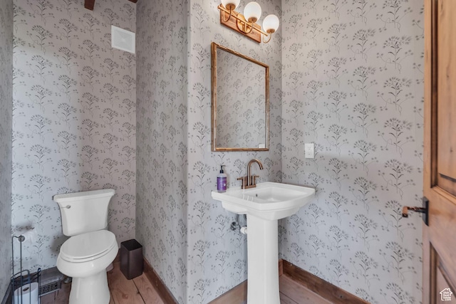 2421 S Navajo Unit Pi-C50, Coalville, UT 84017 - bathroom with wallpapered walls, toilet, baseboards, and wood finished floors