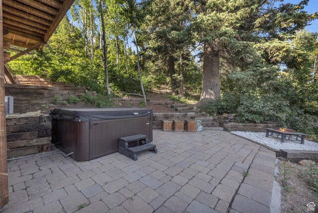 2421 S Navajo Unit Pi-C50, Coalville, UT 84017 - view of patio featuring an outdoor fire pit and a hot tub