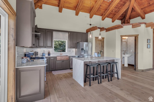 2421 S Navajo Unit Pi-C50, Coalville, UT 84017 - kitchen with light countertops, stainless steel appliances, light wood-type flooring, a breakfast bar area, and wooden ceiling