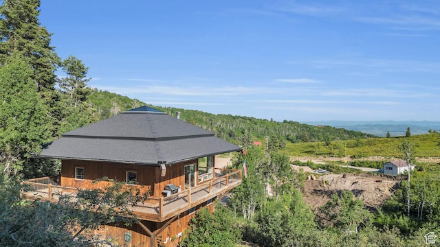2421 S Navajo Unit Pi-C50, Coalville, UT 84017 - back of house with a shingled roof, a deck, and a forest view