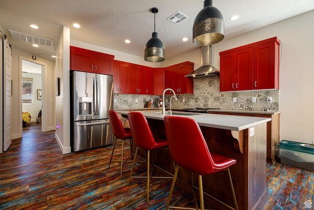 533 E Cutter Trl, Kanab, UT 84741 - kitchen with a sink, visible vents, wall chimney exhaust hood, and stainless steel fridge