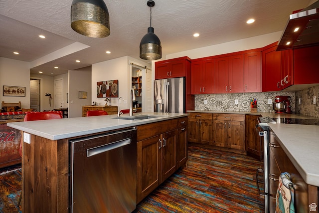 533 E Cutter Trl, Kanab, UT 84741 - kitchen with tasteful backsplash, stainless steel appliances, a sink, wall chimney range hood, and a kitchen island with sink