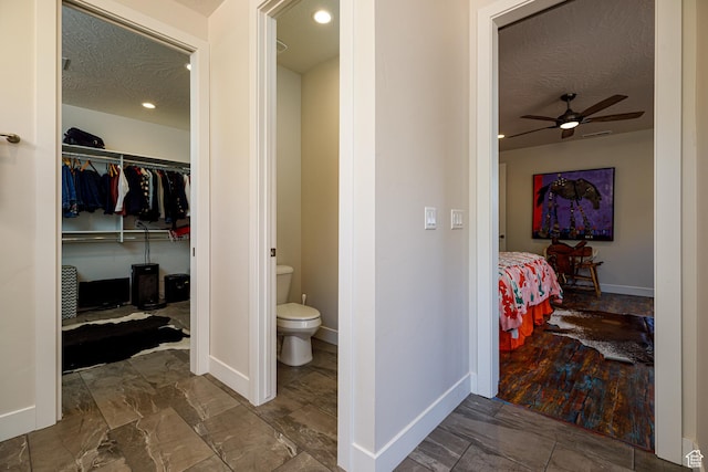 533 E Cutter Trl, Kanab, UT 84741 - ensuite bathroom with a textured ceiling, baseboards, ceiling fan, toilet, and connected bathroom