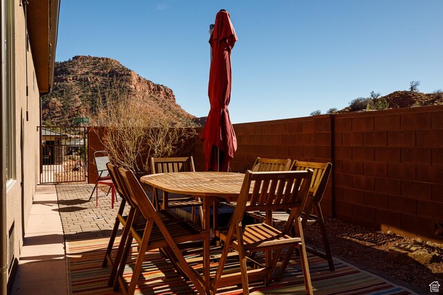 533 E Cutter Trl, Kanab, UT 84741 - view of patio with fence, outdoor dining space, and a mountain view