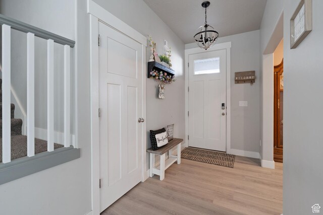 7016 N Amber Mead Ave, Eagle Mountain, UT 84005 - entryway with baseboards, light wood-style floors, and a chandelier