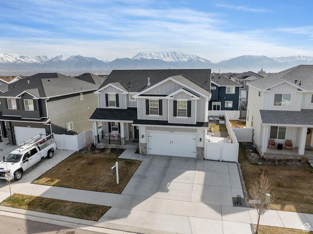 7016 N Amber Mead Ave, Eagle Mountain, UT 84005 - view of front of home featuring stone siding, fence, board and batten siding, and a porch