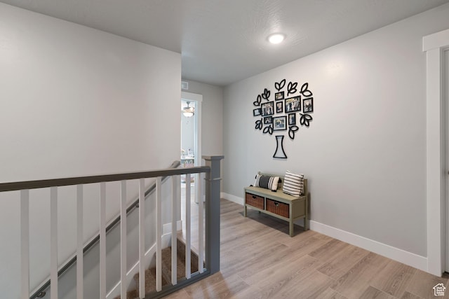 7016 N Amber Mead Ave, Eagle Mountain, UT 84005 - hall with light wood-style flooring, baseboards, and an upstairs landing