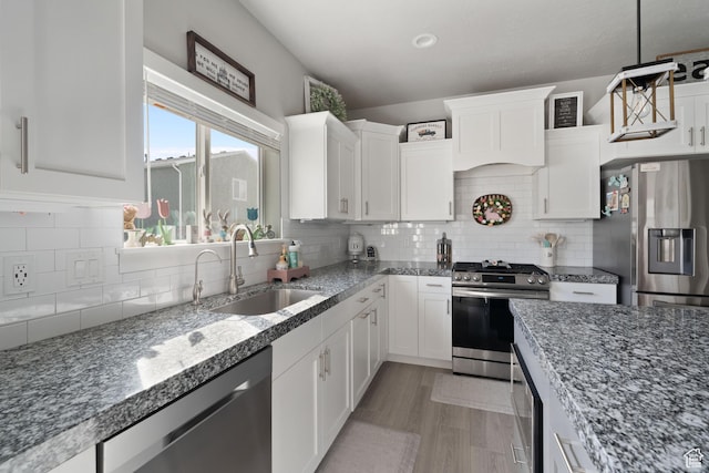 7016 N Amber Mead Ave, Eagle Mountain, UT 84005 - kitchen featuring white cabinets, dark stone countertops, a sink, and stainless steel appliances