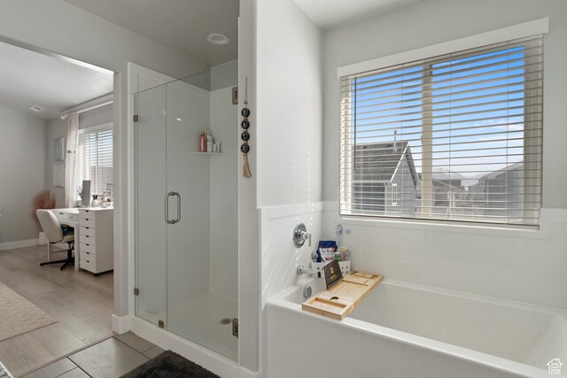7016 N Amber Mead Ave, Eagle Mountain, UT 84005 - full bathroom featuring a shower stall, tile patterned flooring, and a garden tub