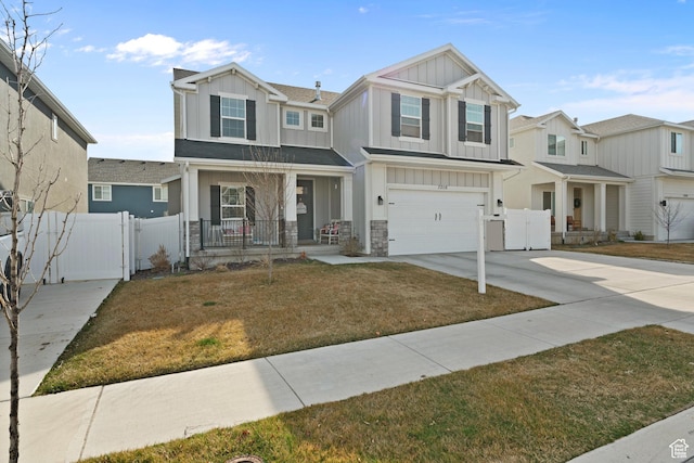 7016 N Amber Mead Ave, Eagle Mountain, UT 84005 - view of front of home featuring a gate, a garage, board and batten siding, driveway, and a porch