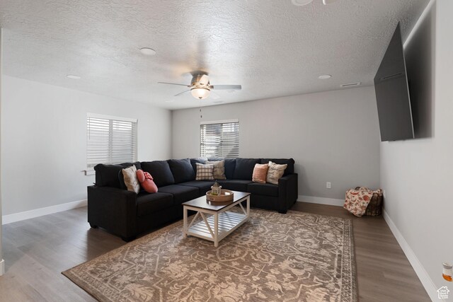 7016 N Amber Mead Ave, Eagle Mountain, UT 84005 - living room with a ceiling fan, baseboards, light wood-style flooring, and visible vents