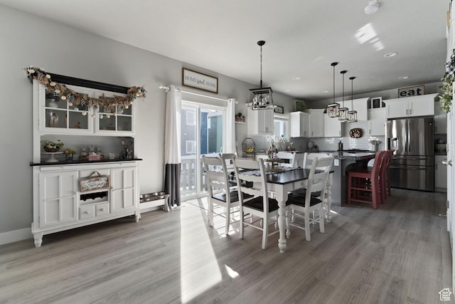 7016 N Amber Mead Ave, Eagle Mountain, UT 84005 - dining space with baseboards and light wood finished floors