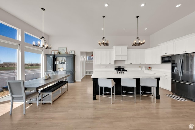 2266 S Betsys Way, Kaysville, UT 84037 - kitchen featuring stainless steel refrigerator with ice dispenser, a chandelier, built in microwave, range, and recessed lighting