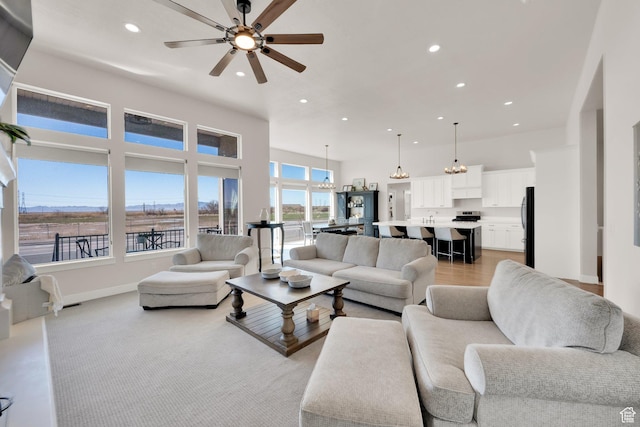 2266 S Betsys Way, Kaysville, UT 84037 - living room with recessed lighting, ceiling fan, a towering ceiling, baseboards, and a chandelier